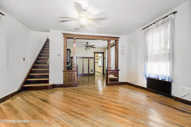 wooden floor in an empty room with a window