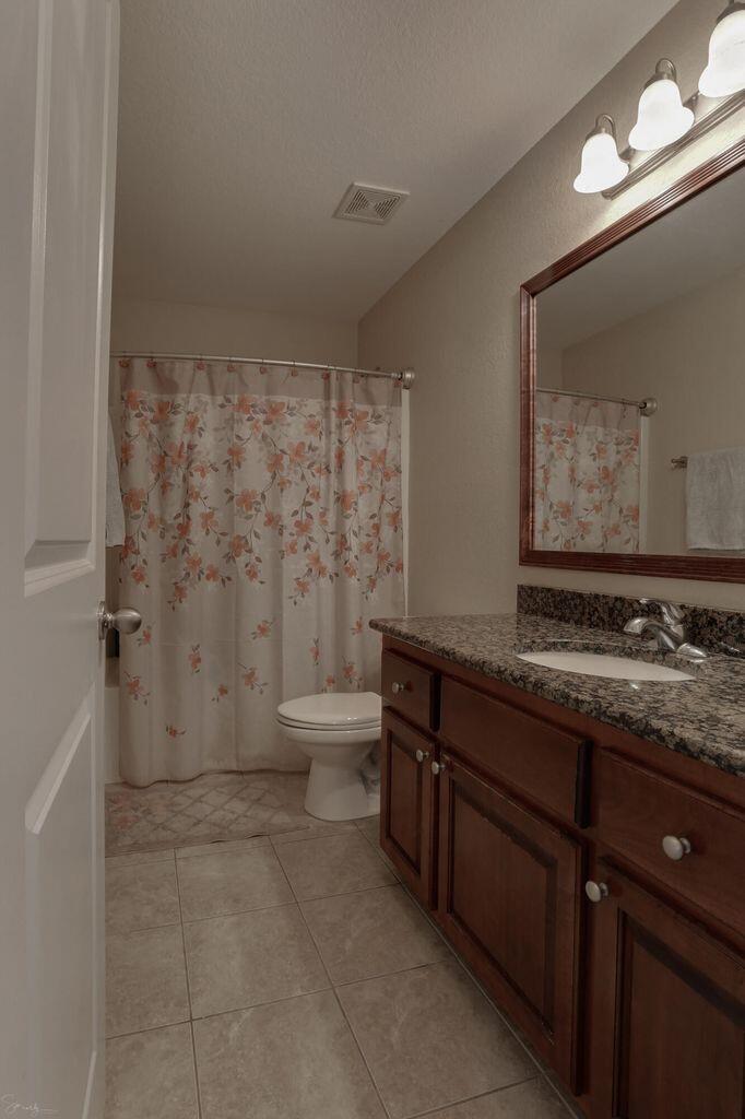136 Leonine Hollow Crestview, FL 32536 - Photo 15 of 27 a bathroom with a granite countertop sink a toilet and bathtub