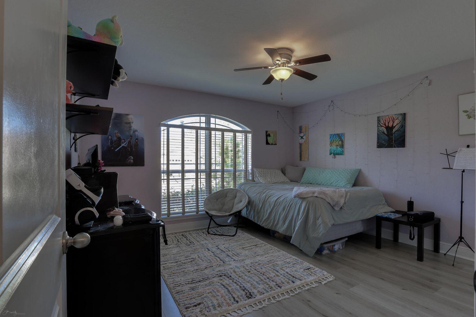 136 Leonine Hollow Crestview, FL 32536 - Photo 16 of 27 a spacious bedroom with a bed and a chandelier