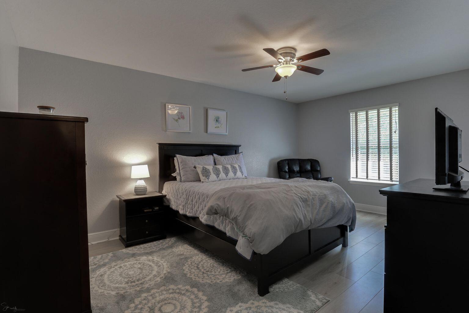 136 Leonine Hollow Crestview, FL 32536 - Photo 19 of 27 a bedroom with a bed and a chandelier