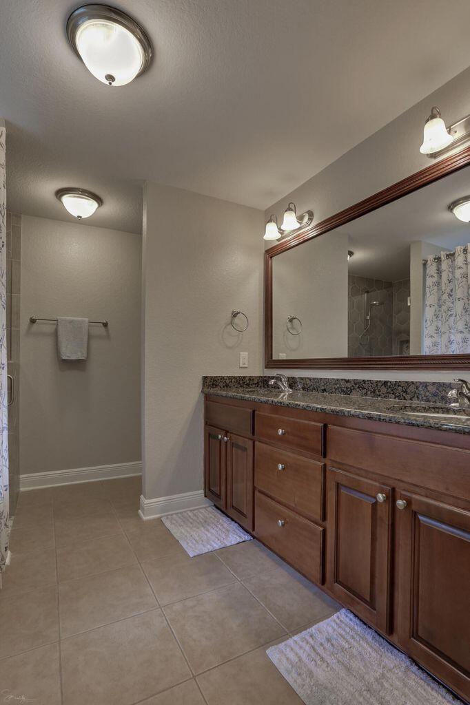 136 Leonine Hollow Crestview, FL 32536 - Photo 23 of 27 a bathroom with a granite countertop sink a mirror and a shower