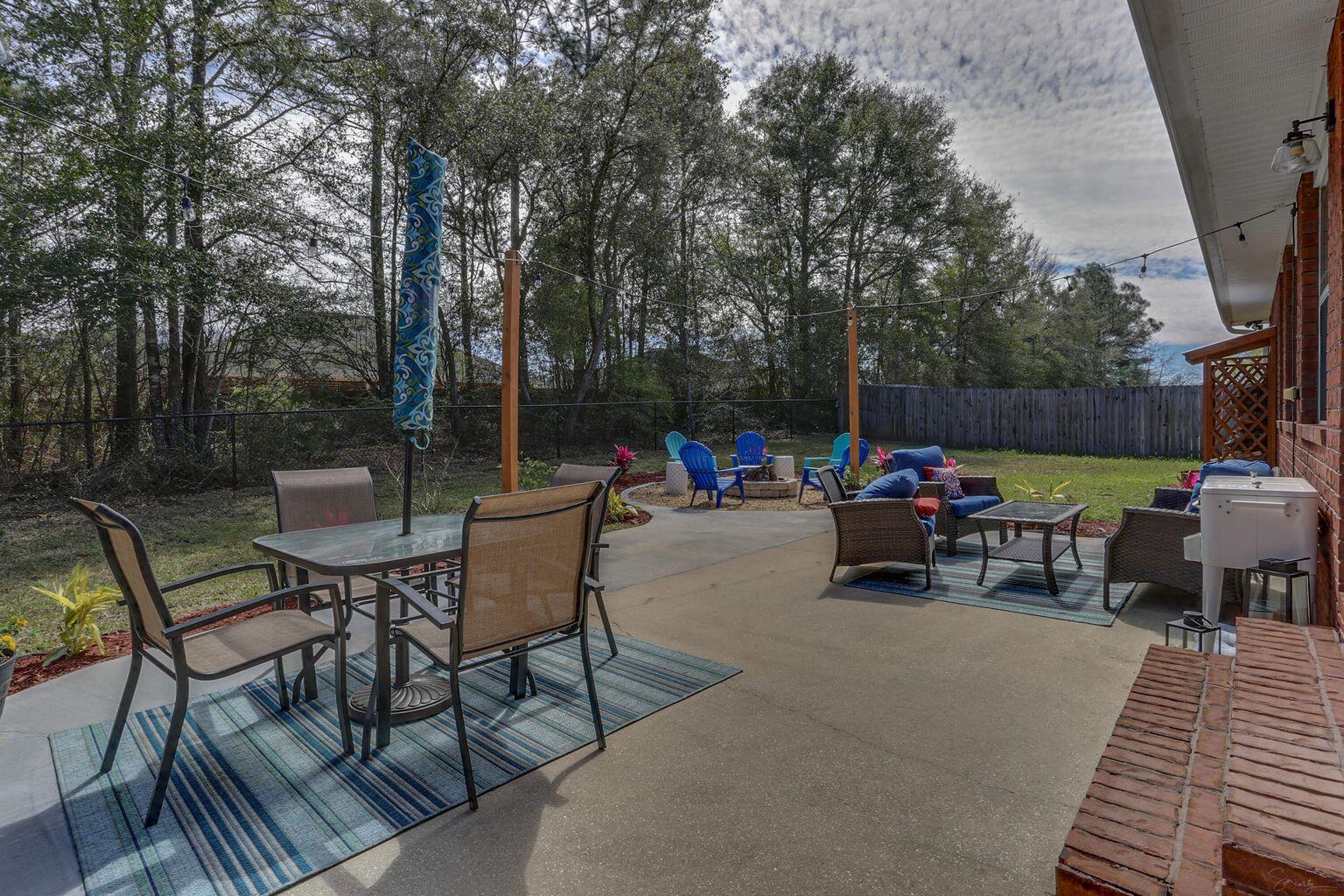 136 Leonine Hollow Crestview, FL 32536 - Photo 26 of 27 a view of a chairs and tables in the back yard of the house