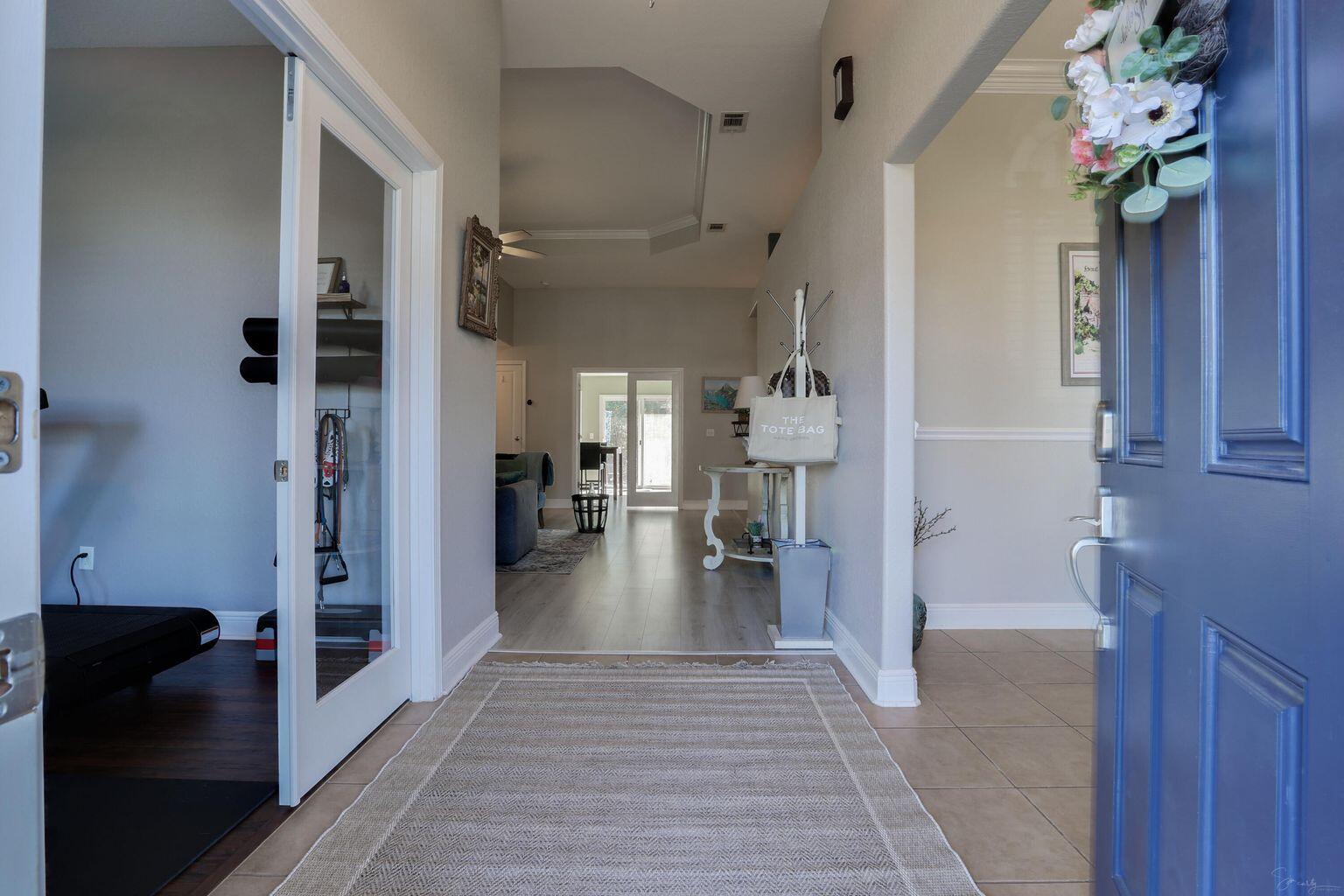 136 Leonine Hollow Crestview, FL 32536 - Photo 3 of 27 a view of a hallway view with wooden floor and living room