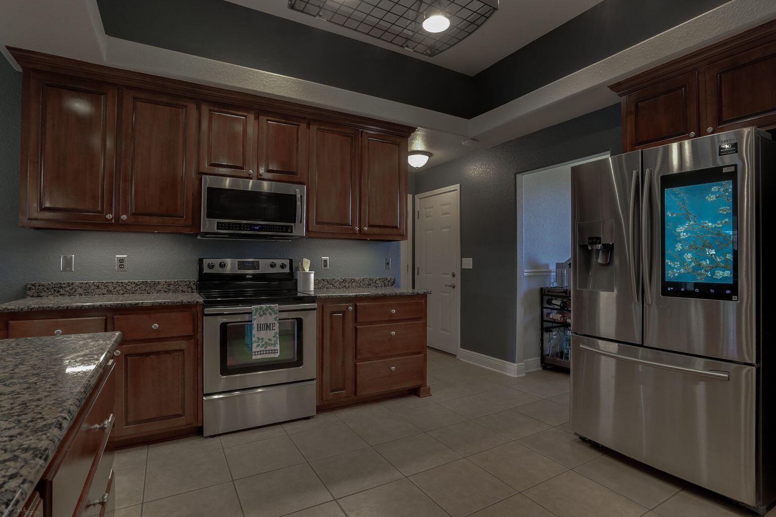 136 Leonine Hollow Crestview, FL 32536 - Photo 9 of 27 a kitchen with stainless steel appliances granite countertop a refrigerator stove and microwave