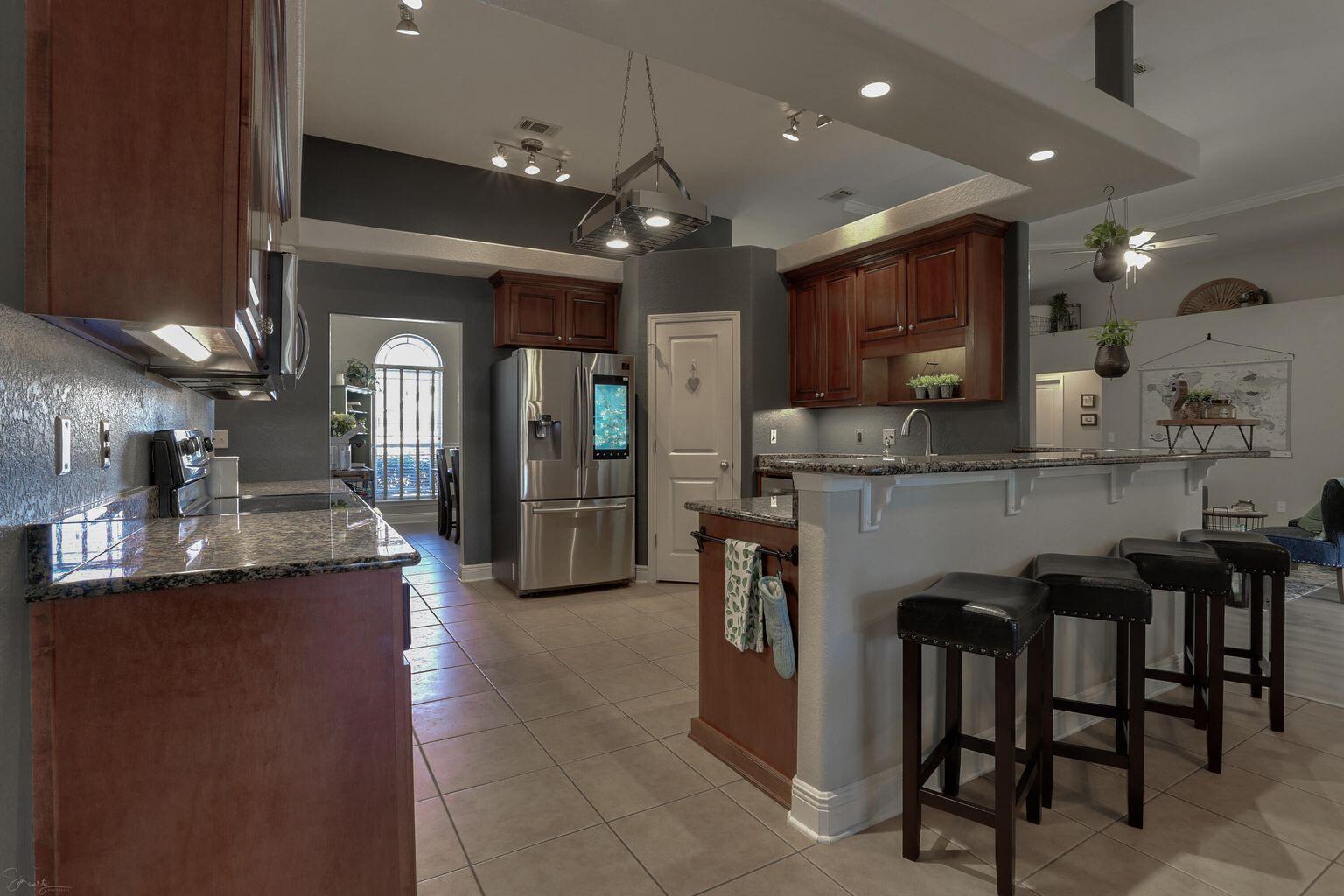 136 Leonine Hollow Crestview, FL 32536 - Photo 10 of 27 a kitchen with kitchen island granite countertop a table and chairs in it