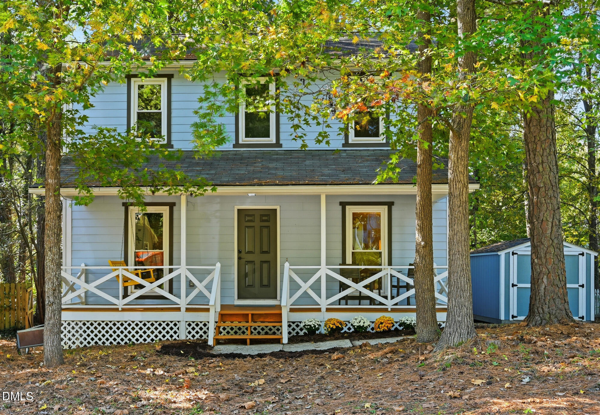 a view of a house with a large window and potted plants