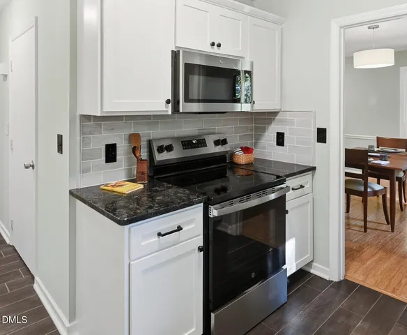 a kitchen with stainless steel appliances granite countertop a stove and a microwave