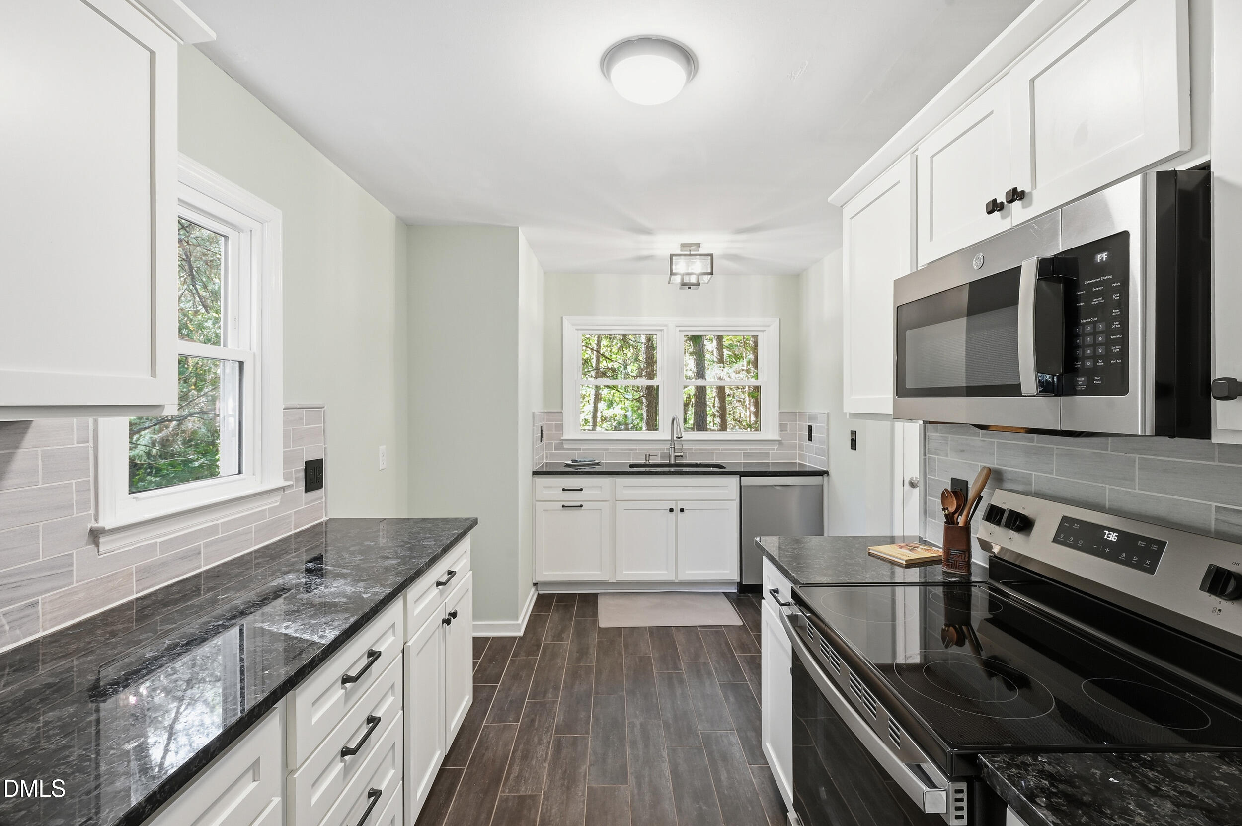 4 Little Spring Lane Durham, NC 27707 - Photo 12 of 34 a kitchen with a stove a sink and a microwave