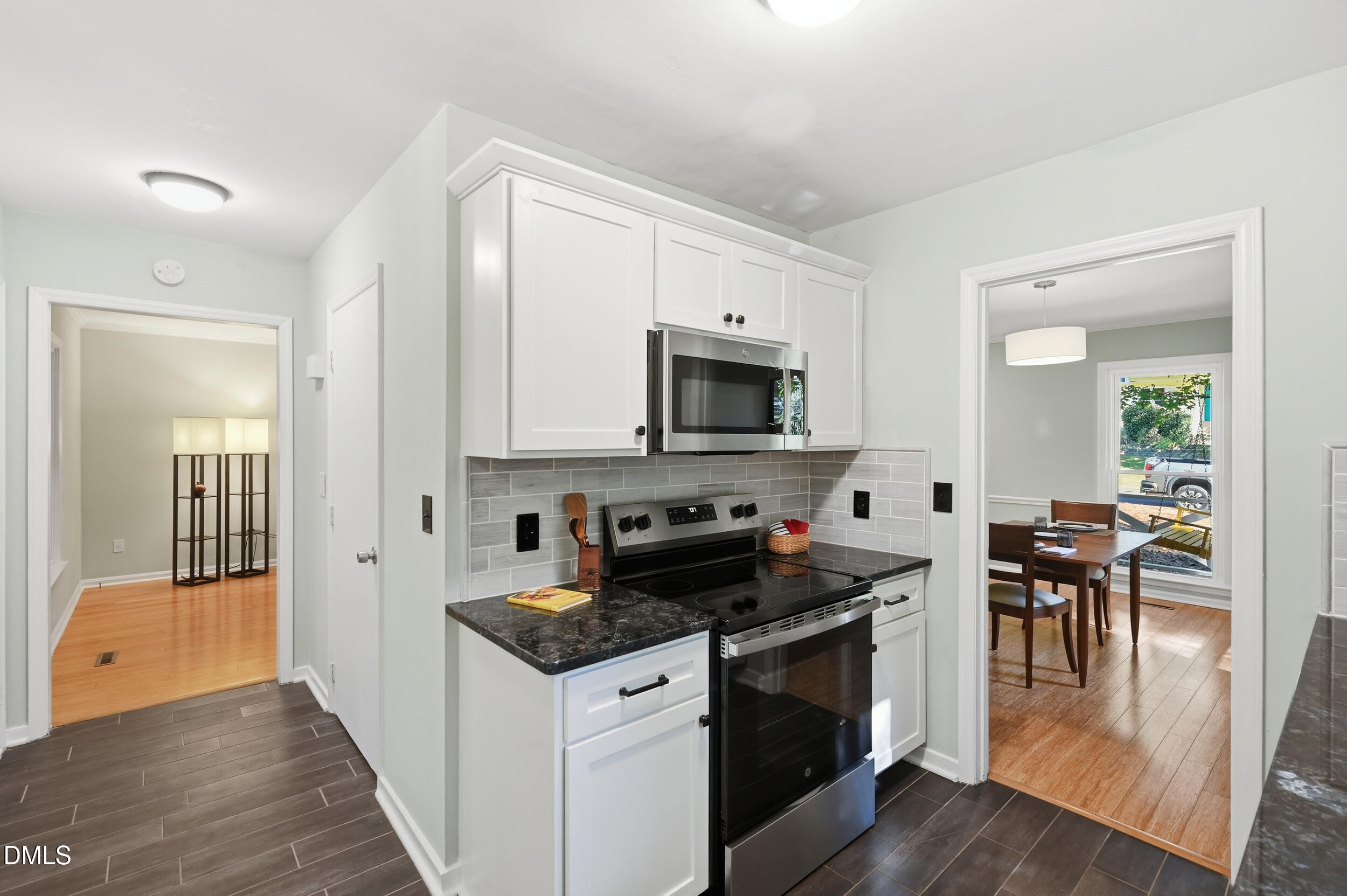 4 Little Spring Lane Durham, NC 27707 - Photo 13 of 34 a kitchen with granite countertop a stove a sink and a refrigerator