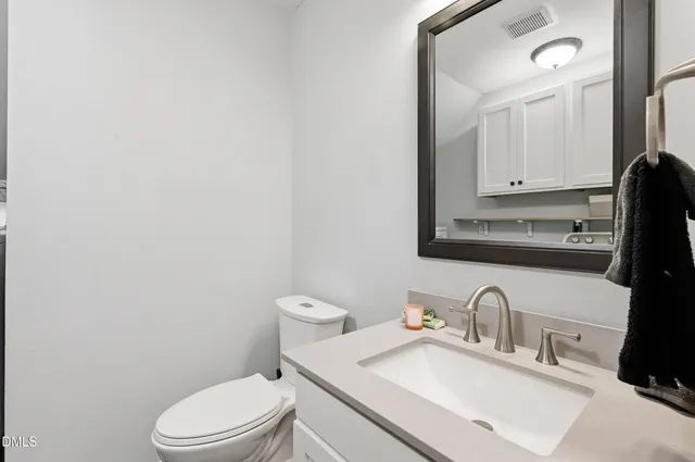 a bathroom with a sink a toilet and mirror