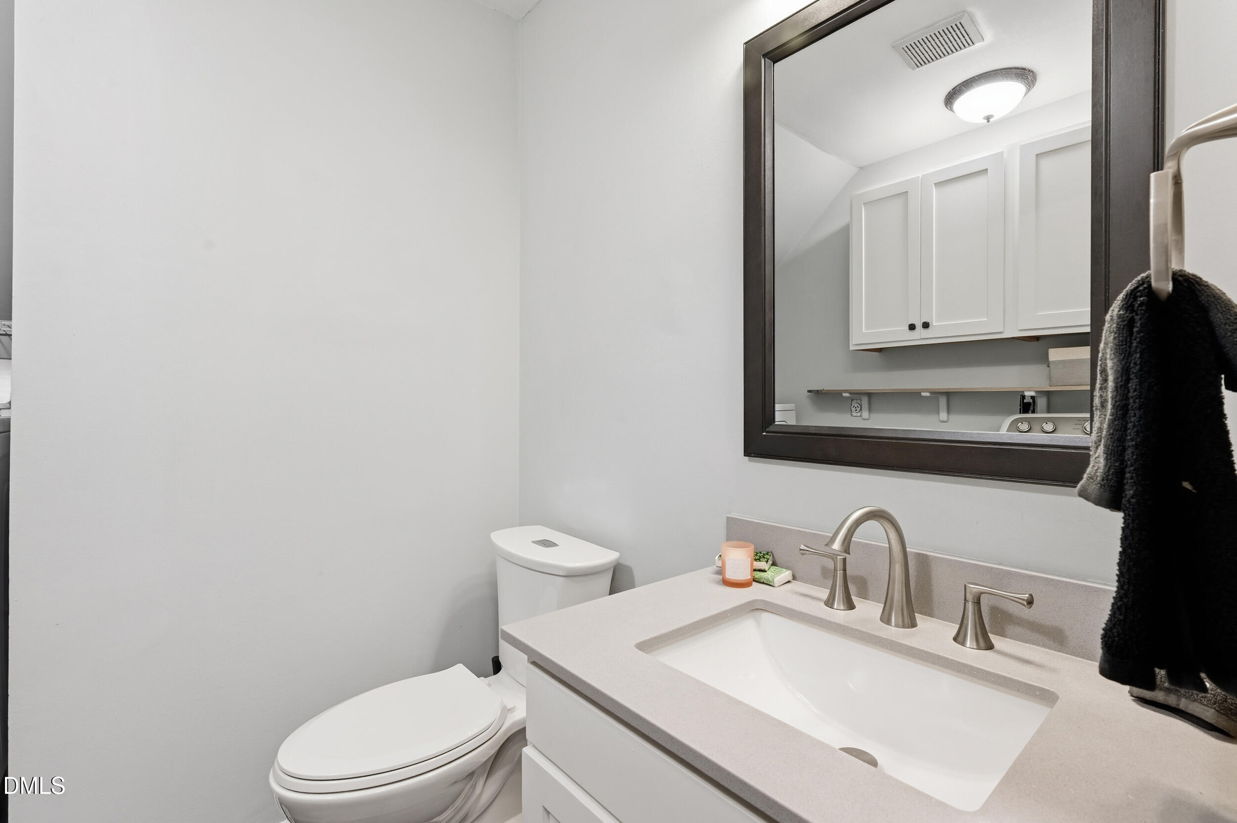4 Little Spring Lane Durham, NC 27707 - Photo 14 of 34 a bathroom with a sink a toilet and mirror