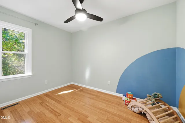 a bedroom with bed and window