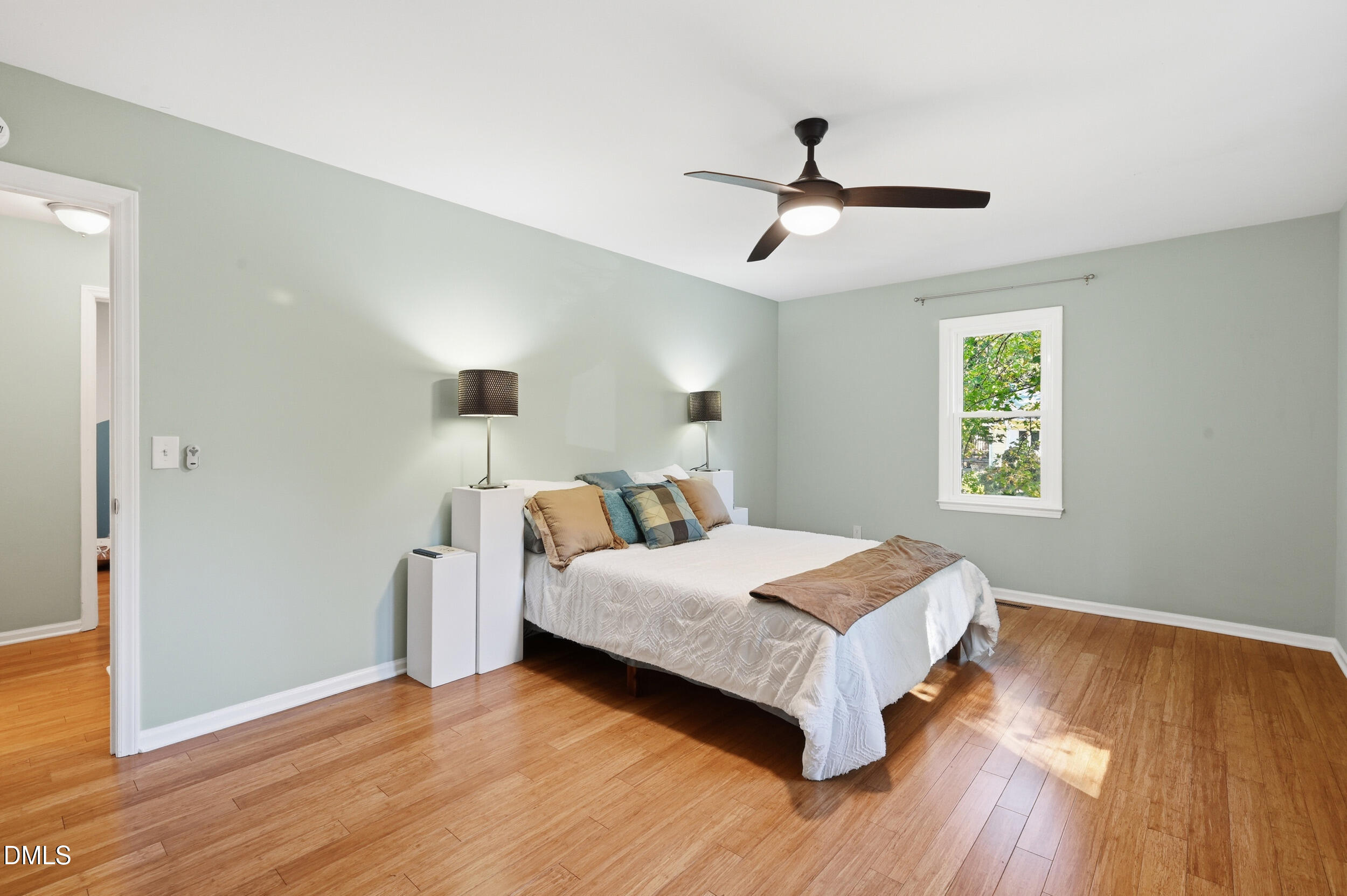 4 Little Spring Lane Durham, NC 27707 - Photo 21 of 34 a bedroom with a bed and wooden floor