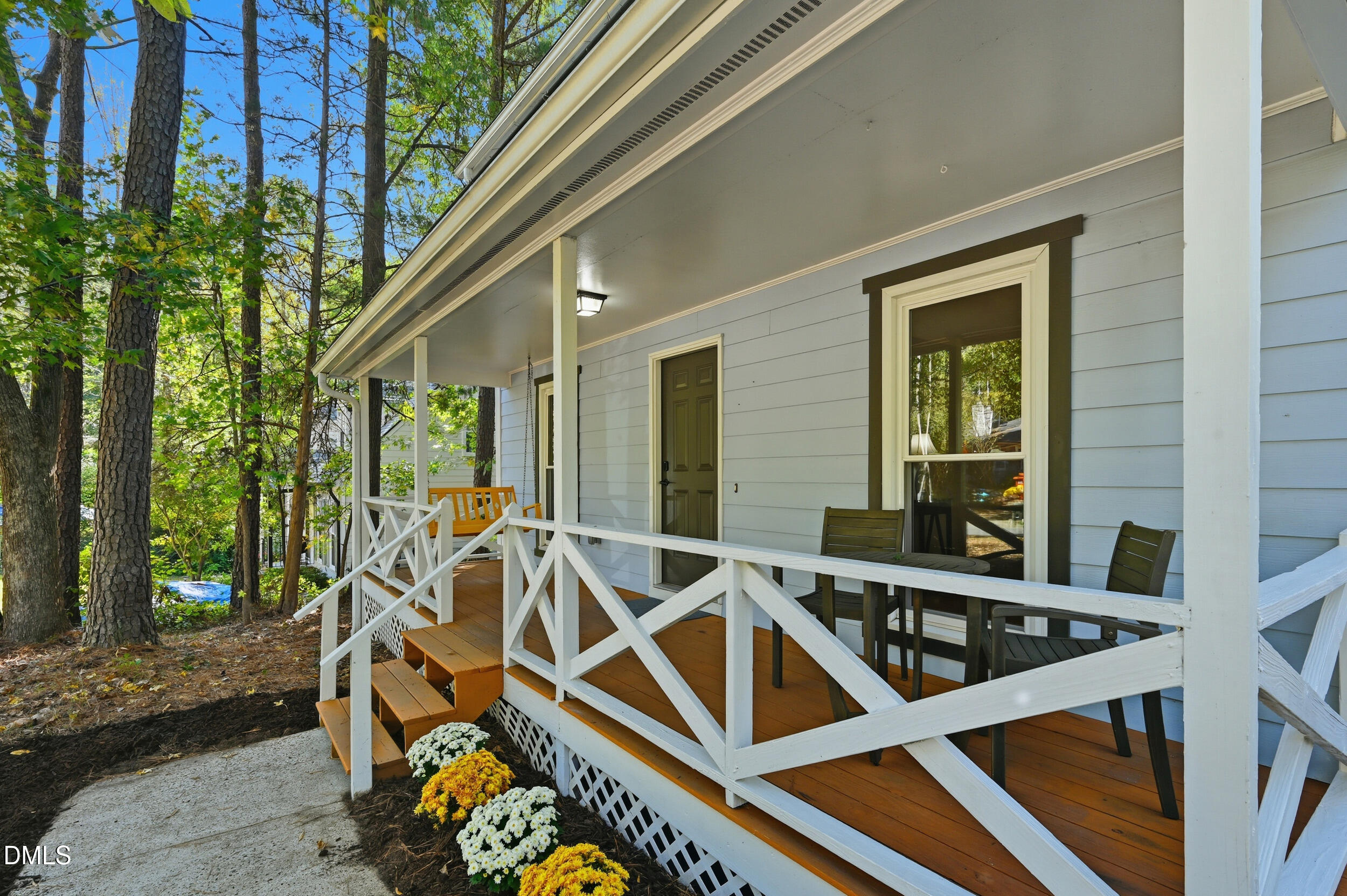 4 Little Spring Lane Durham, NC 27707 - Photo 3 of 34 a view of a patio with table and chairs and wooden floor