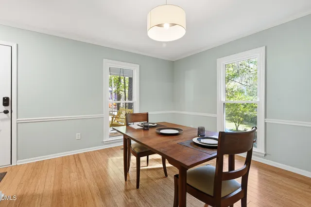 a view of a dining room with furniture window and wooden floor