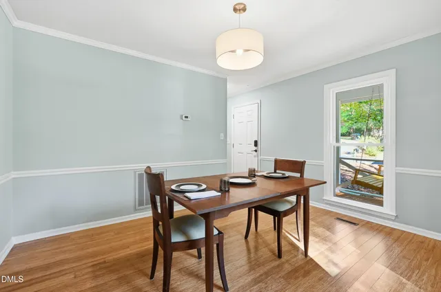 a view of a dining room with furniture and wooden floor