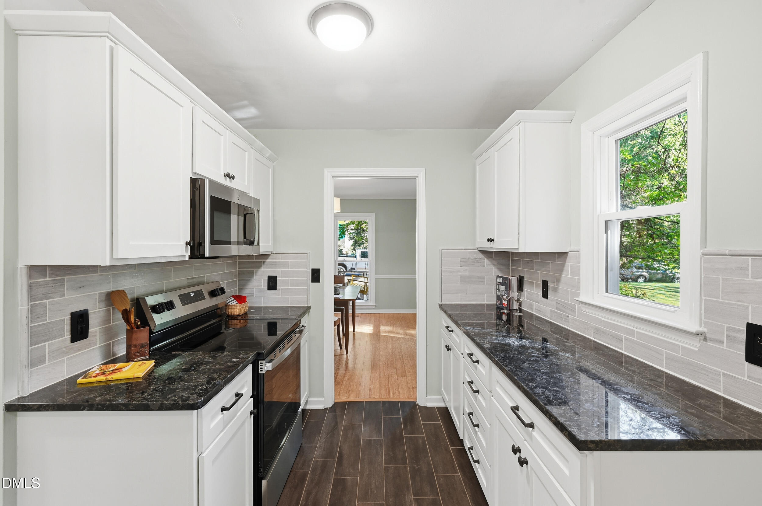 4 Little Spring Lane Durham, NC 27707 - Photo 10 of 34 a kitchen with granite countertop a sink a counter space appliances and cabinets