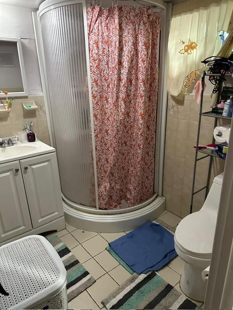 135-40 Alwick Road Queens, NY 11420 - Photo 18 of 38 a bathroom with a toilet and a shower