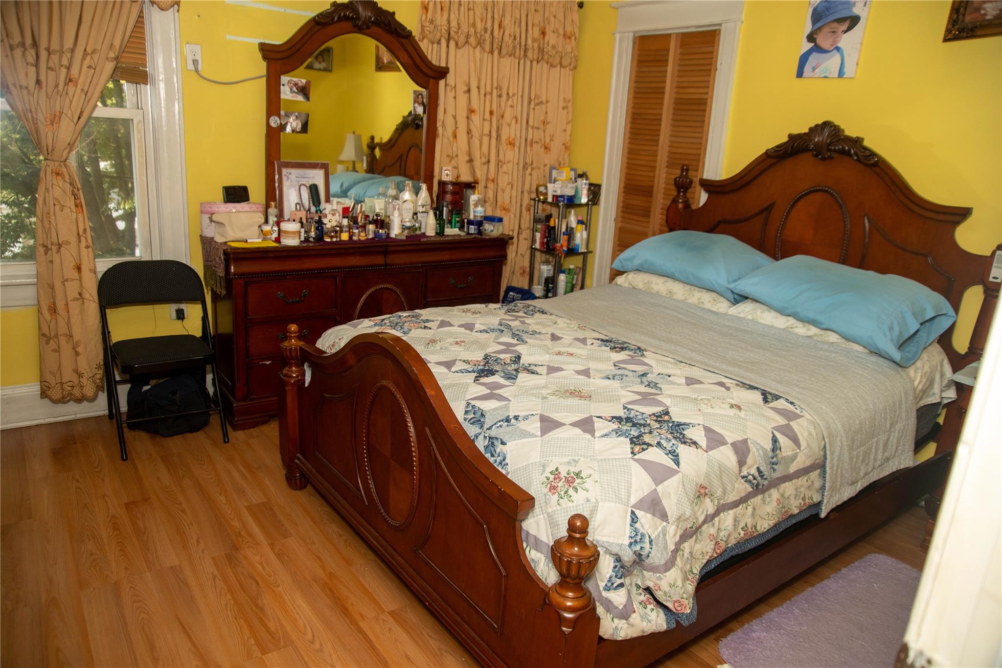 135-40 Alwick Road Queens, NY 11420 - Photo 25 of 38 a bed sitting in a bedroom next to a window