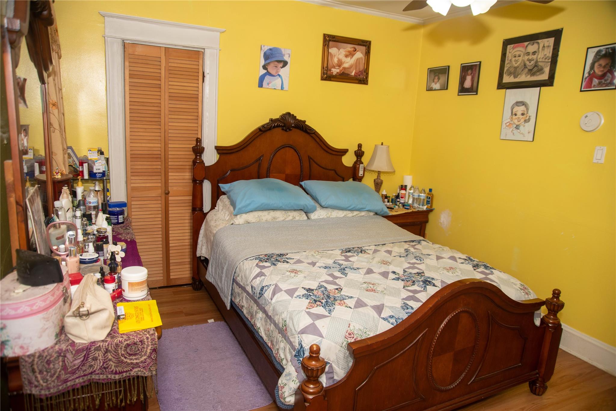 135-40 Alwick Road Queens, NY 11420 - Photo 27 of 38 a bed sitting in a bedroom next to a blue wall
