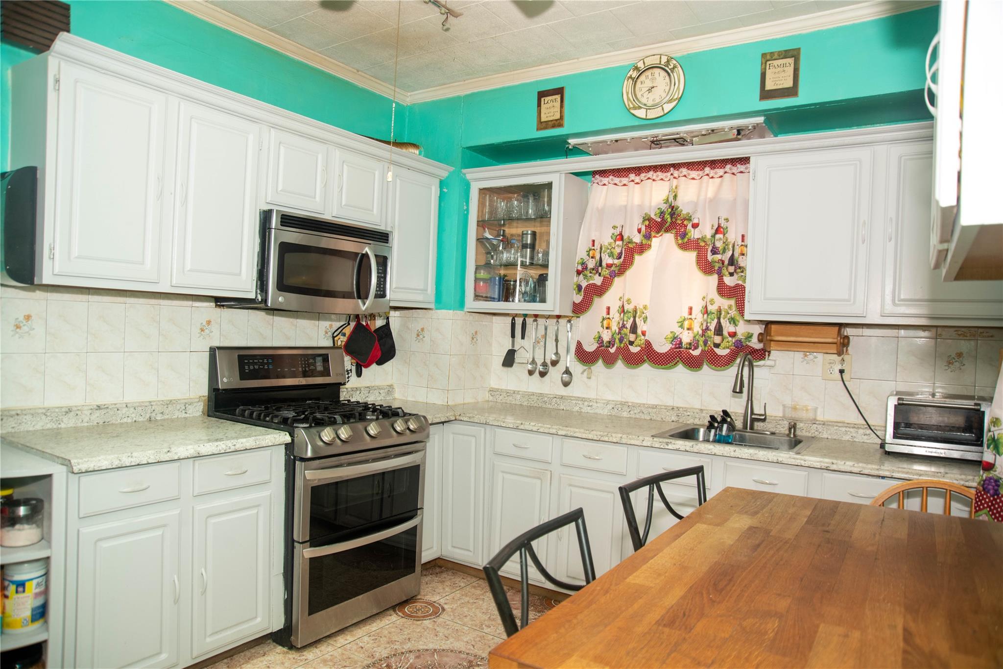 135-40 Alwick Road Queens, NY 11420 - Photo 9 of 38 a kitchen with stainless steel appliances a stove a sink and a microwave