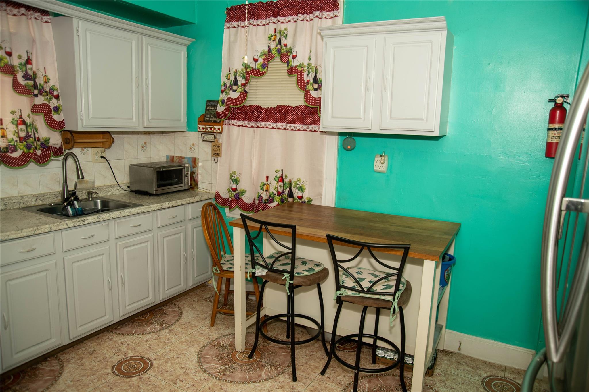 135-40 Alwick Road Queens, NY 11420 - Photo 10 of 38 a kitchen with stainless steel appliances cabinets table and chairs