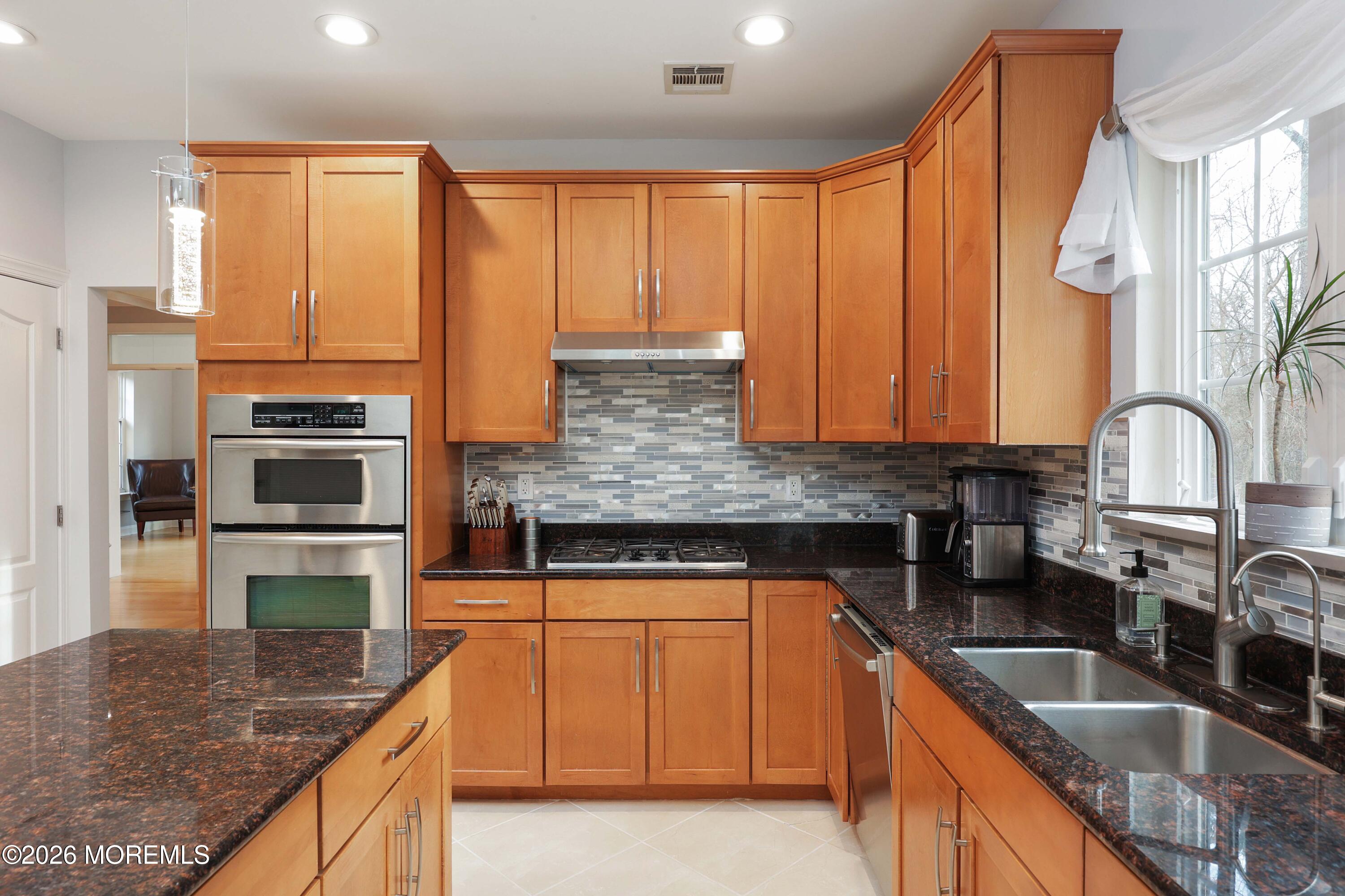 14 Emily Road Manalapan, NJ 07726 - Photo 11 of 44 a kitchen with granite countertop a sink a counter top space appliances and cabinets