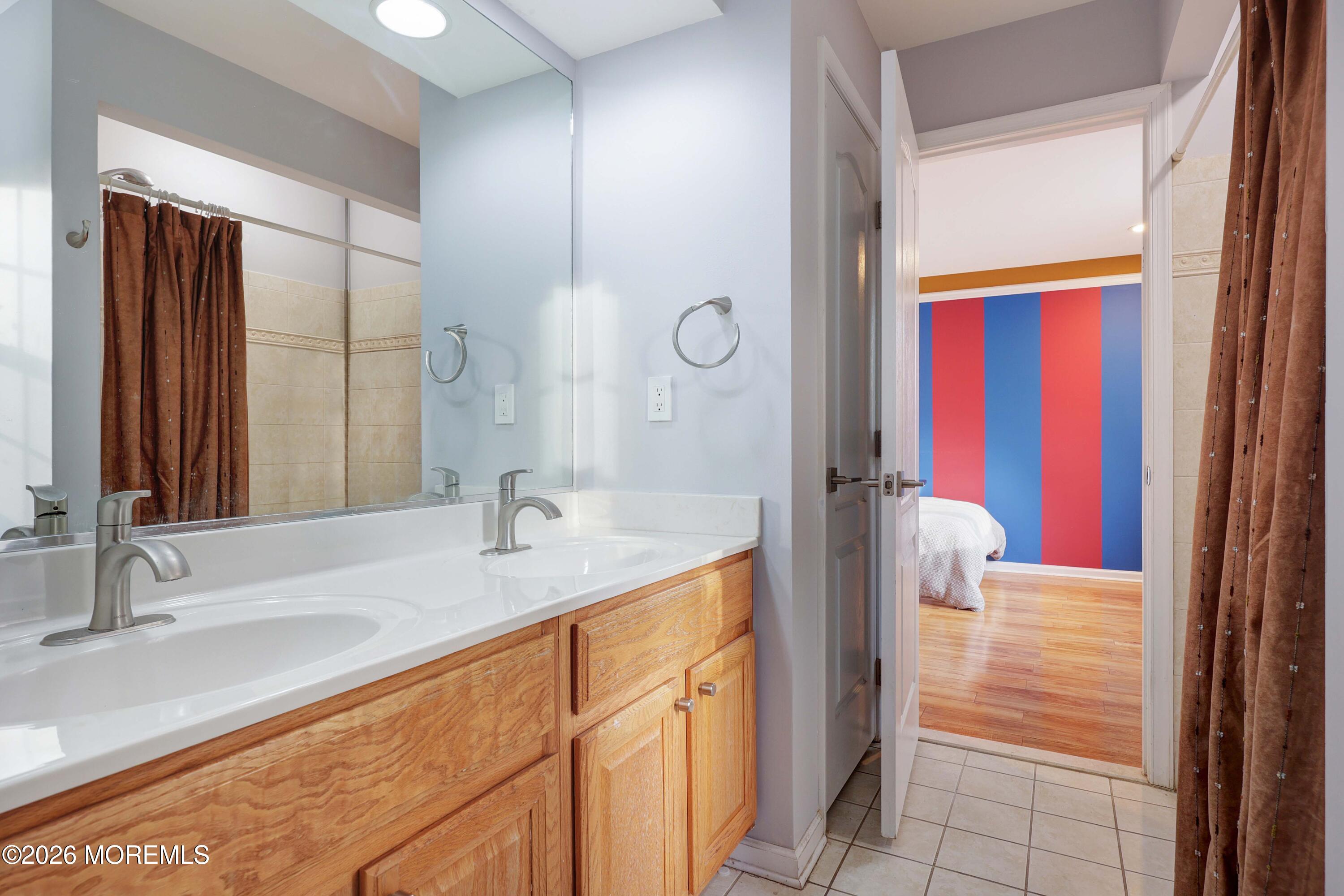 14 Emily Road Manalapan, NJ 07726 - Photo 18 of 44 a bathroom with a granite countertop sink and a mirror