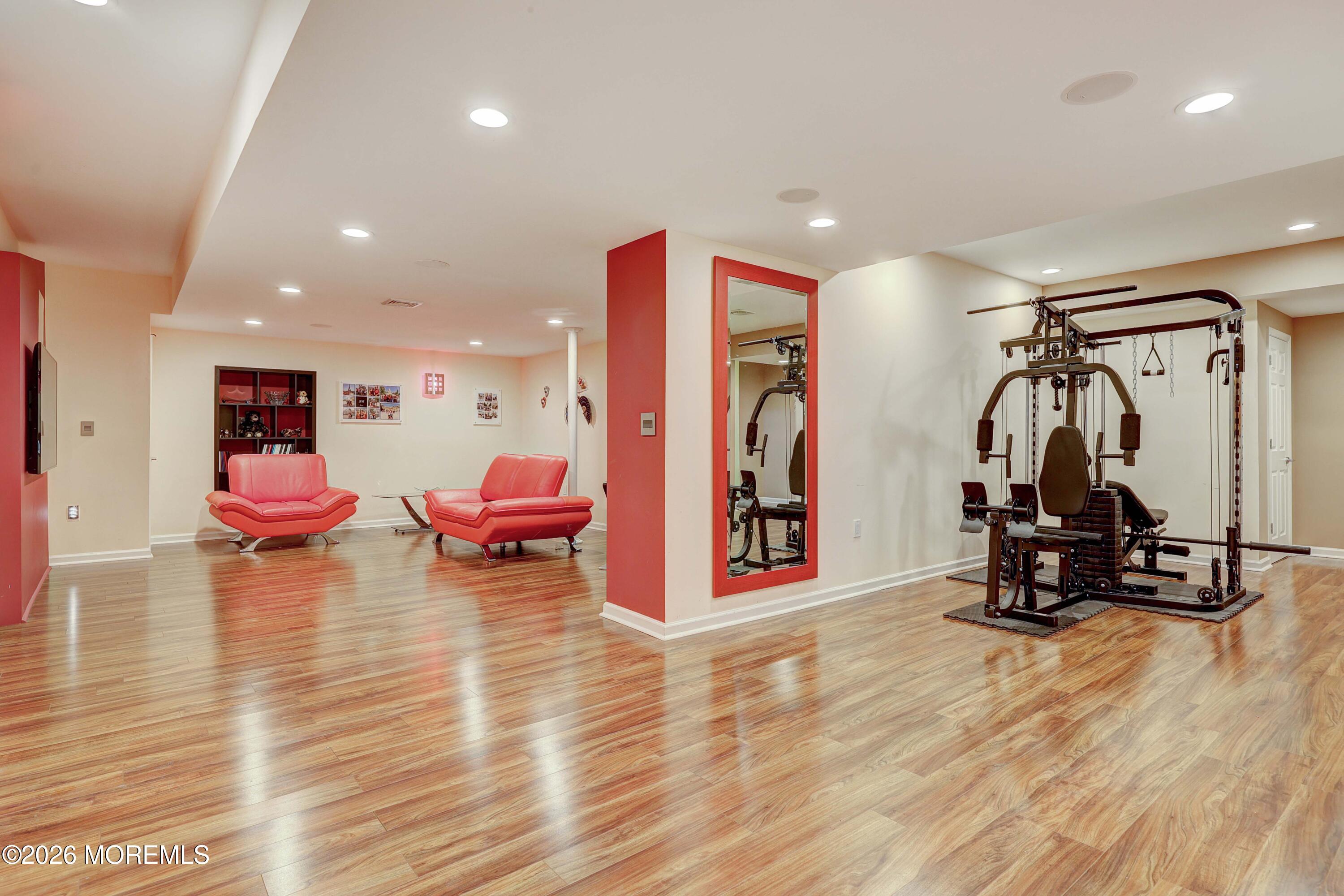 14 Emily Road Manalapan, NJ 07726 - Photo 20 of 44 a living room with furniture and gym equipment