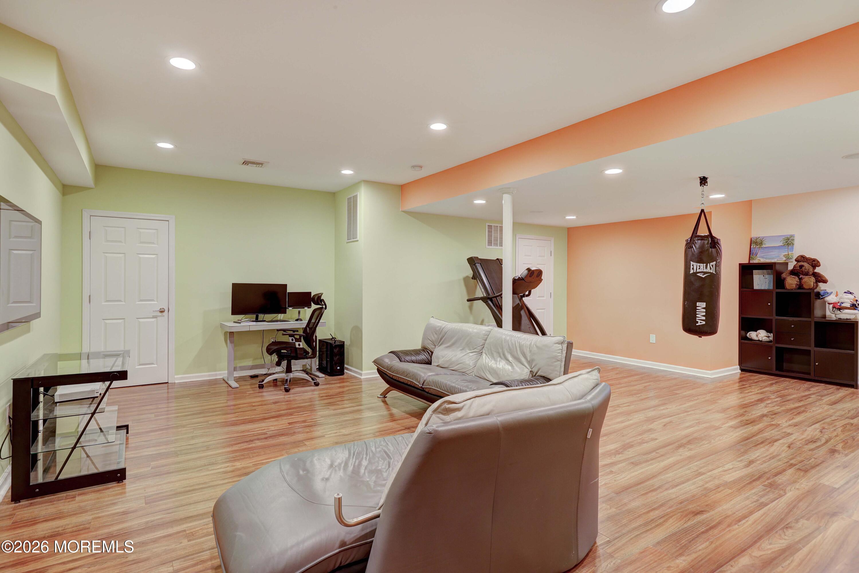 14 Emily Road Manalapan, NJ 07726 - Photo 21 of 44 a living room with furniture and a flat screen tv