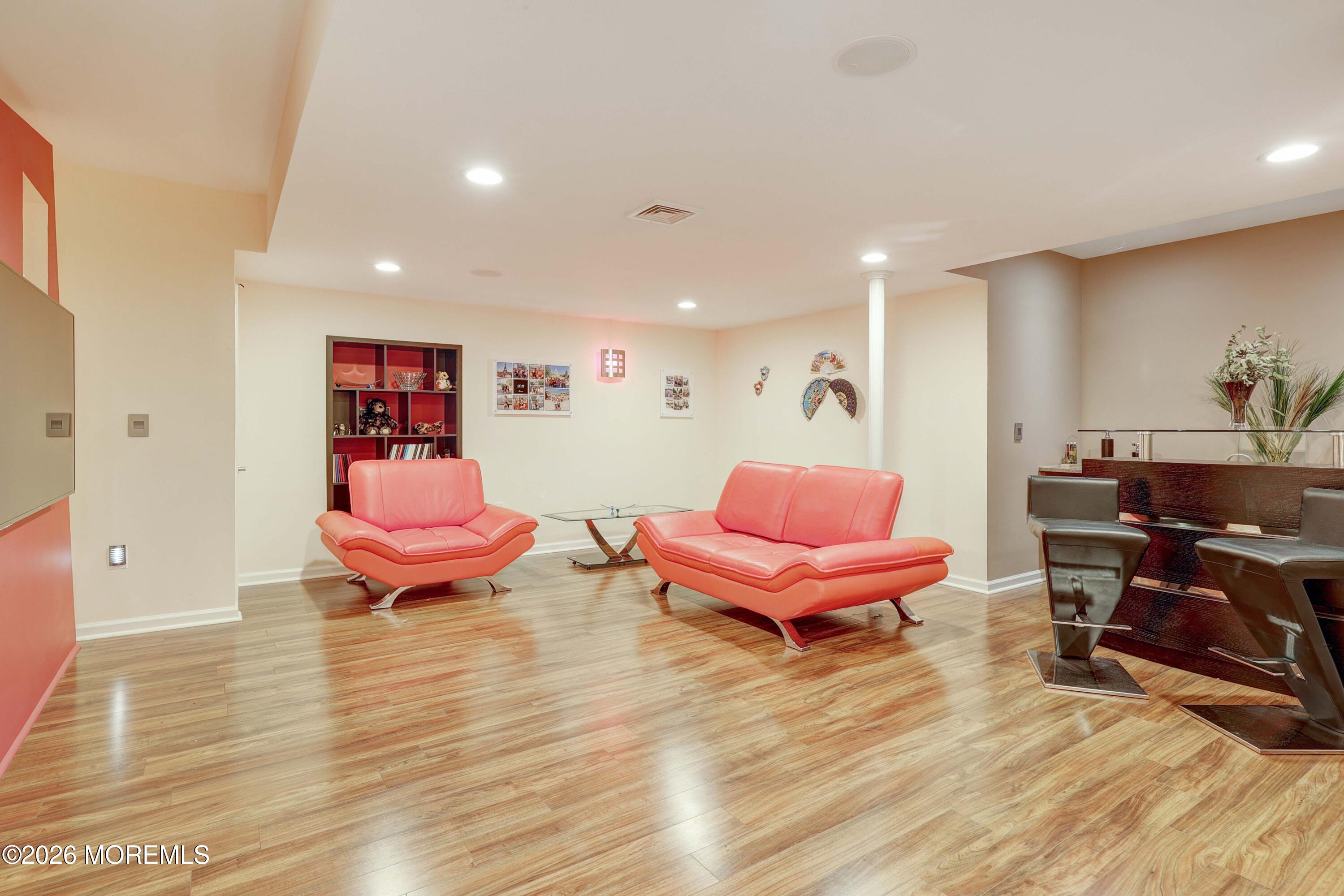 14 Emily Road Manalapan, NJ 07726 - Photo 23 of 44 a living room with furniture and a wooden floor