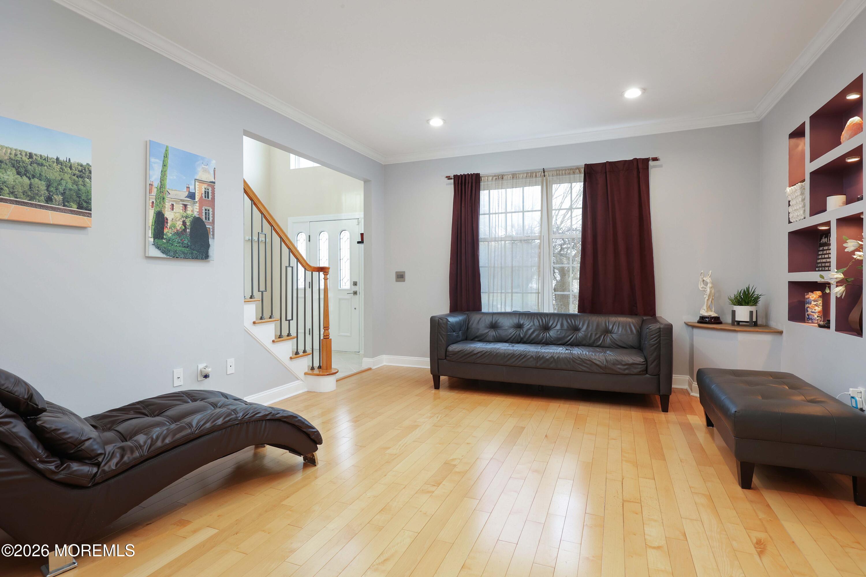 14 Emily Road Manalapan, NJ 07726 - Photo 35 of 44 a living room with furniture and a book shelf
