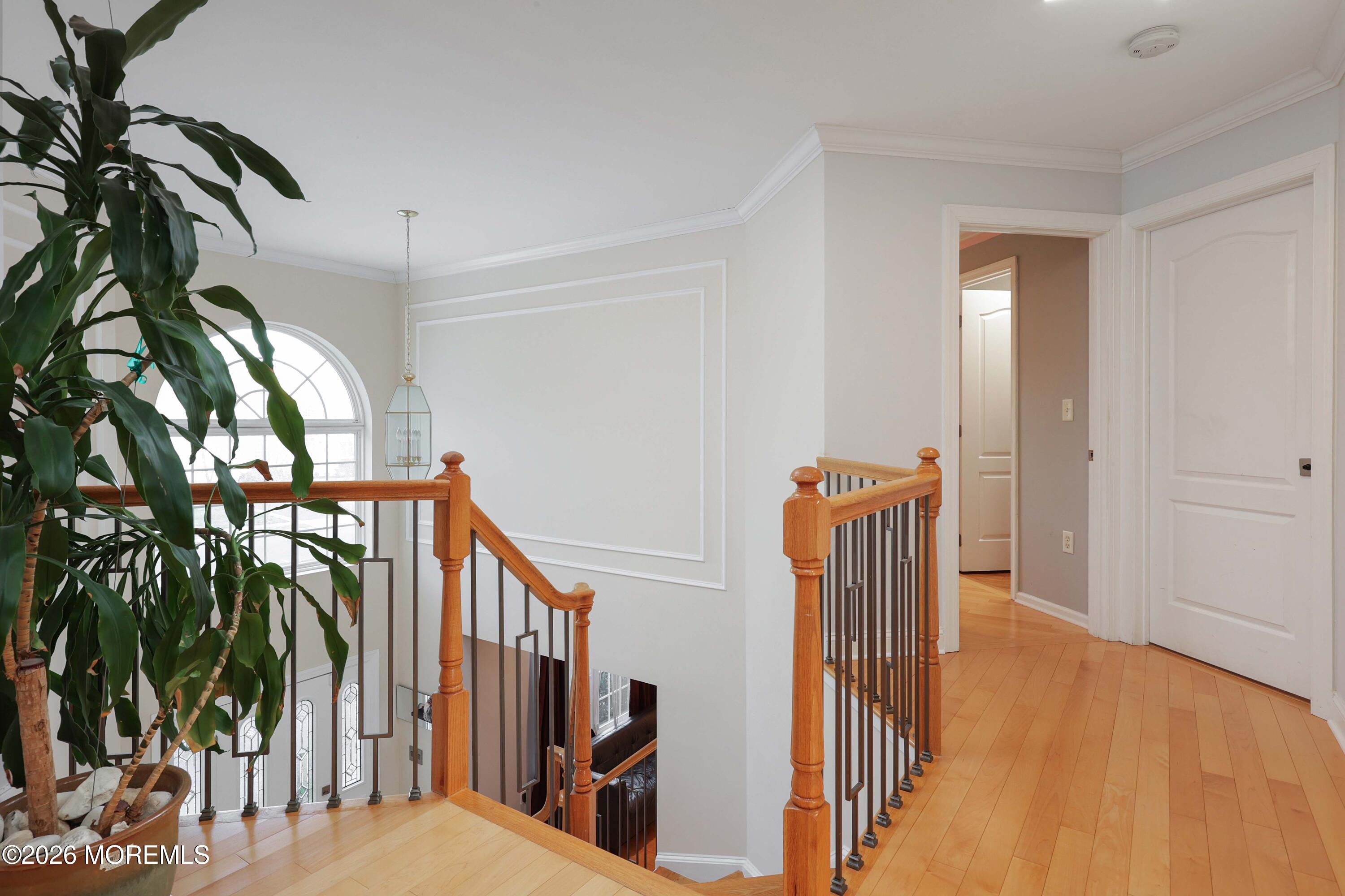 14 Emily Road Manalapan, NJ 07726 - Photo 39 of 44 a view of a hallway with wooden floor and staircase