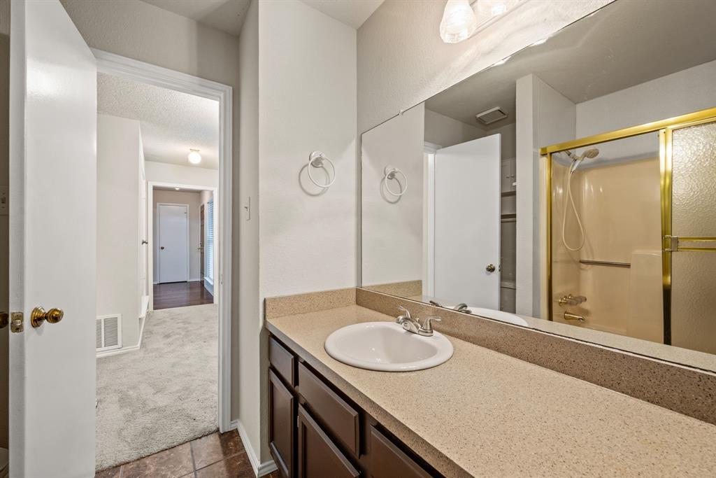 6605 Bluebonnet Drive Rowlett, TX 75089 - Photo 18 of 25 a bathroom with a sink and a mirror