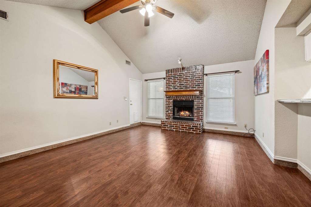 6605 Bluebonnet Drive Rowlett, TX 75089 - Photo 2 of 25 an empty room with wooden floor fireplace and windows