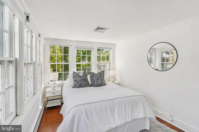 a bedroom with a large bed and a large window