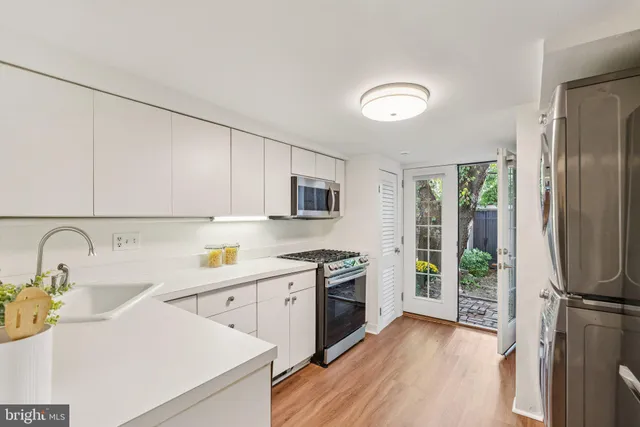 a kitchen with a sink appliances and cabinets