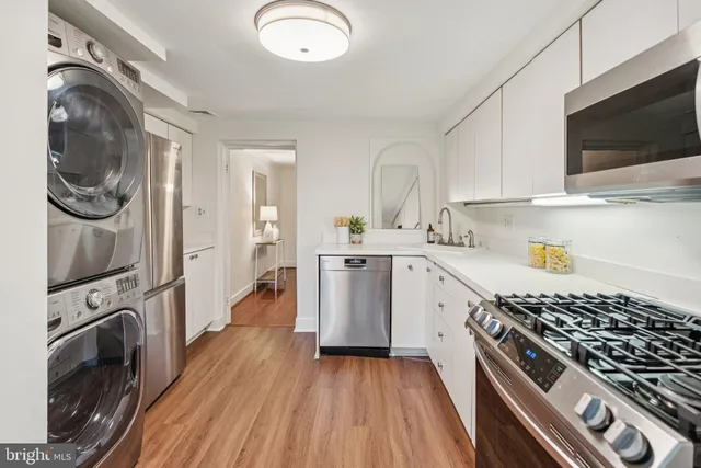 a kitchen with stainless steel appliances granite countertop a stove a sink and a refrigerator
