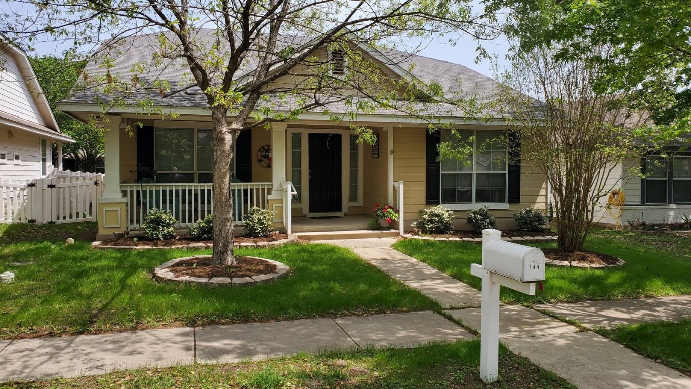 744 Scheel Road Kyle, TX 78640 - Photo 1 of 1 a front view of a house with a garden