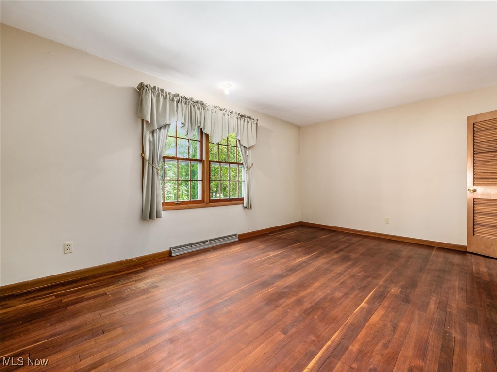 975 Richey Road Zanesville, OH 43701 - Photo 3 of 27 Spare room featuring hardwood / wood-style flooring, a baseboard heating unit, and baseboards