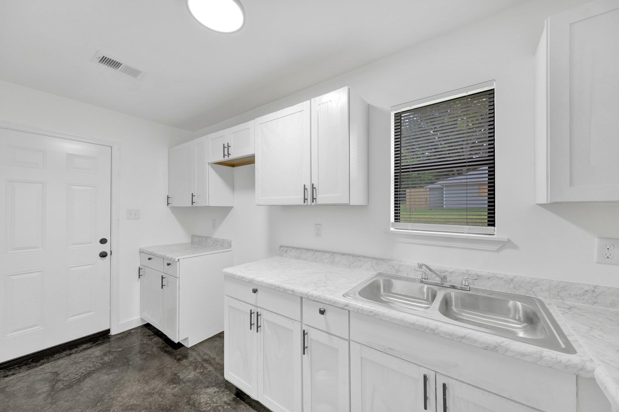 653 Gilleas Road Memphis, TN 38109 - Photo 15 of 24 a kitchen with cabinets appliances and a sink