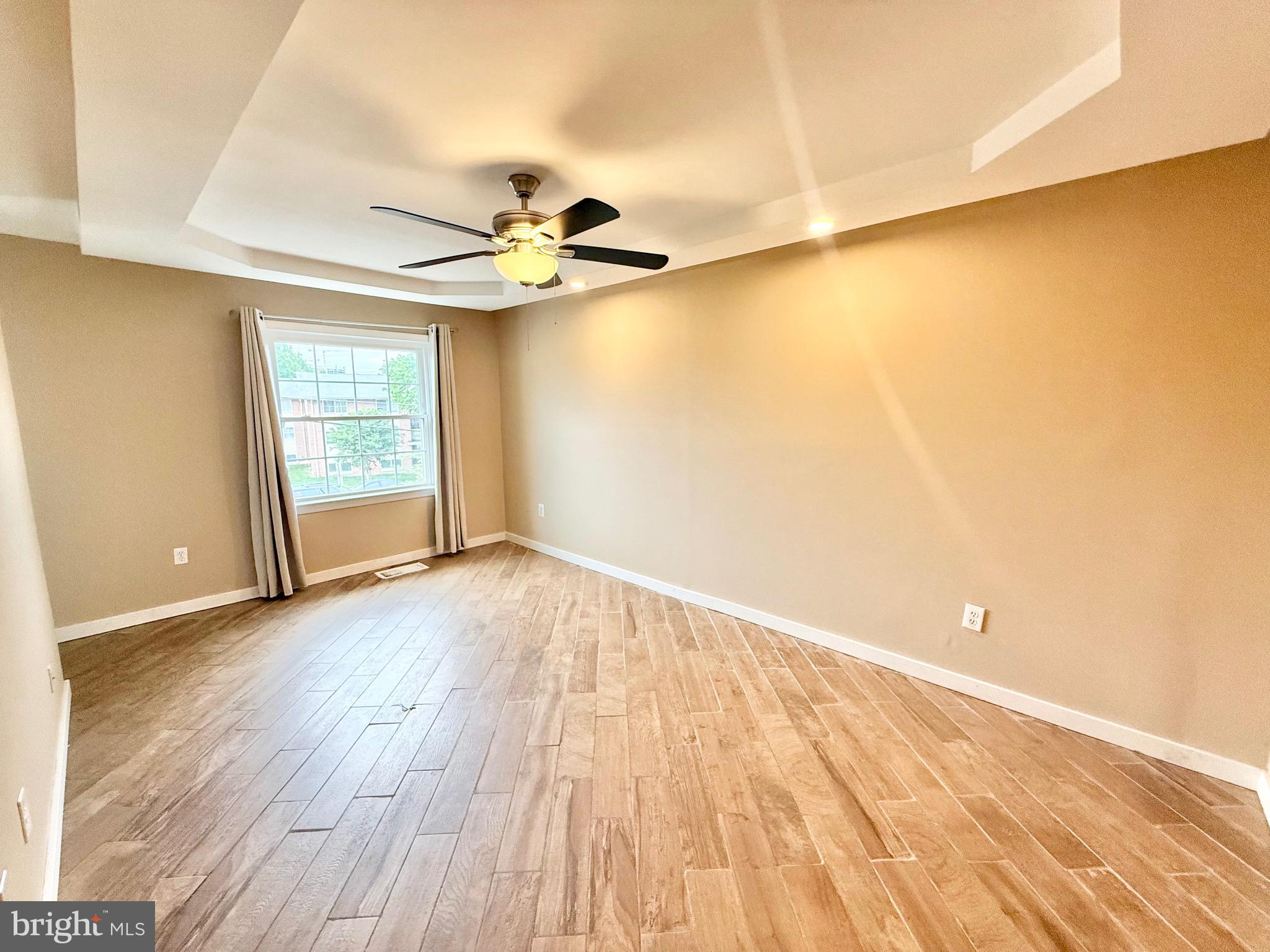 5439 Richenbacher Avenue Alexandria, VA 22304 - Photo 11 of 23 wooden floor in an empty room with a window