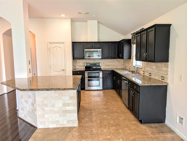a view of wooden floor and windows in a kitchen
