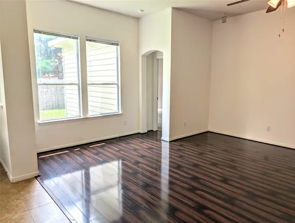 a open kitchen with stainless steel appliances granite countertop a refrigerator a sink dishwasher a stove and a dining table with wooden floor