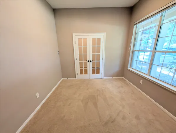 a view of a room with a windows and ceiling fan