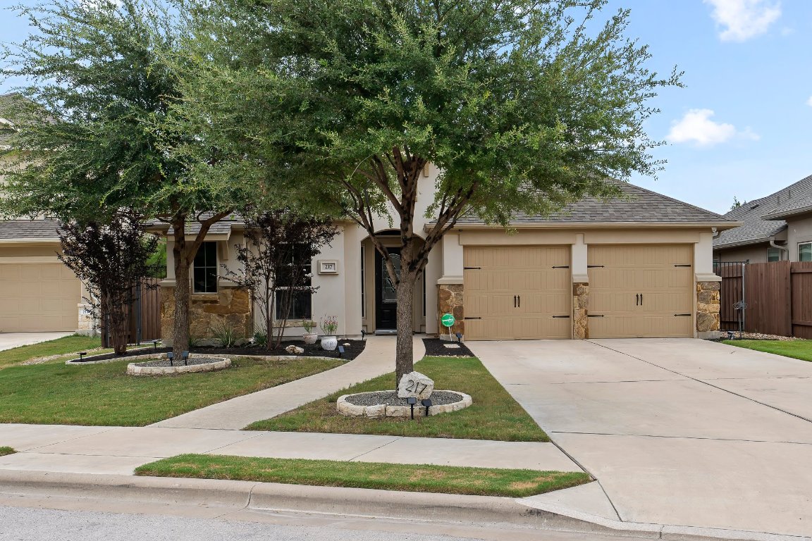 217 Serrano Street Georgetown, TX 78628 - Photo 1 of 27 a front view of a house with a yard