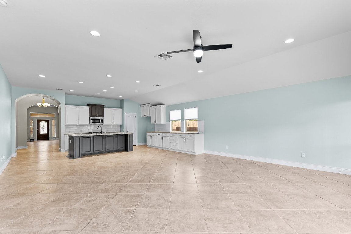 217 Serrano Street Georgetown, TX 78628 - Photo 17 of 27 a view of a kitchen with a sink and a refrigerator