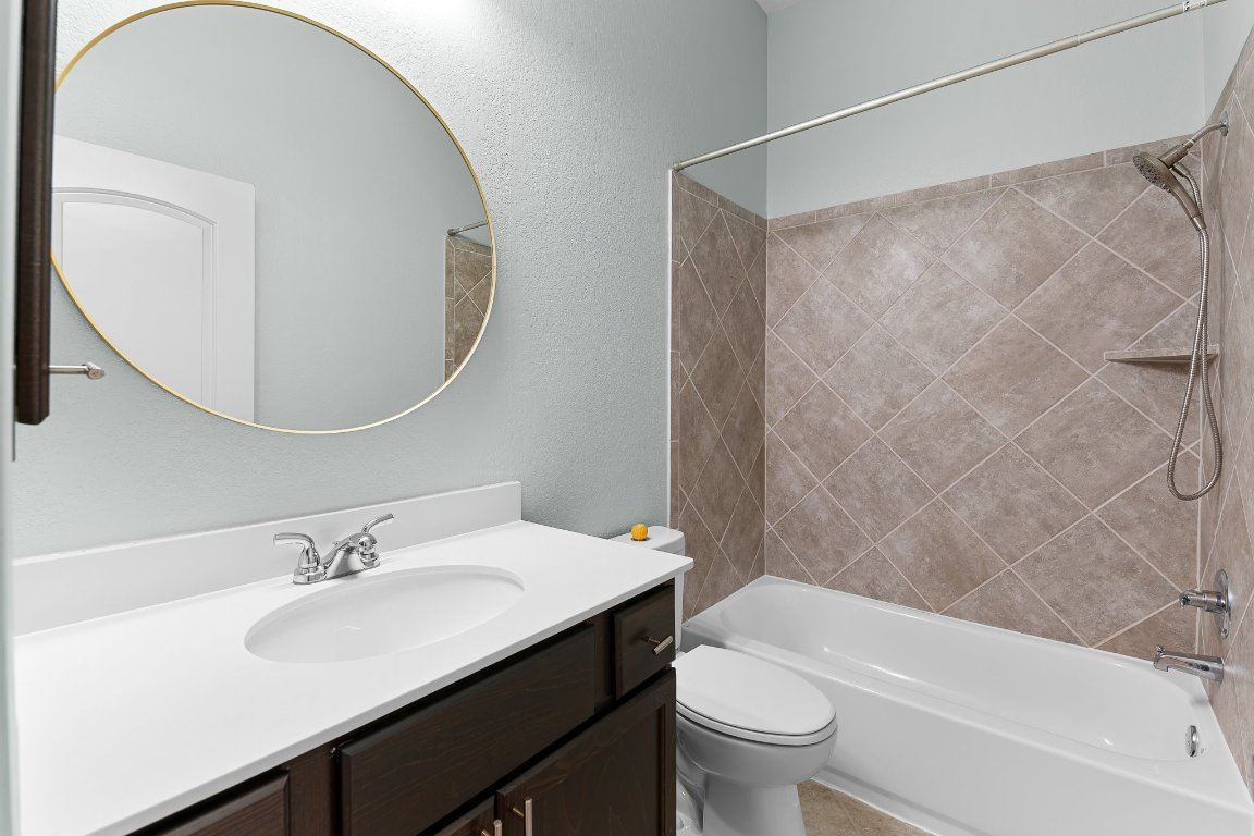 217 Serrano Street Georgetown, TX 78628 - Photo 19 of 27 a bathroom with a sink and a mirror