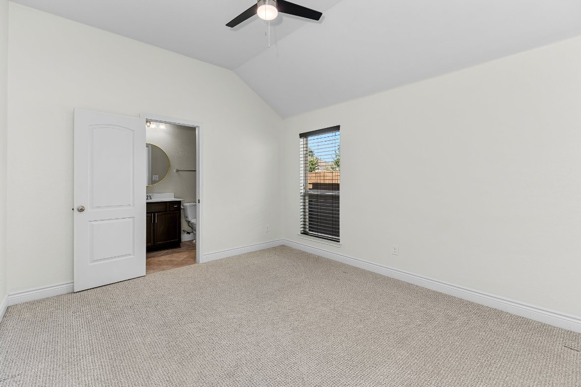 217 Serrano Street Georgetown, TX 78628 - Photo 6 of 27 an empty room with closet and windows