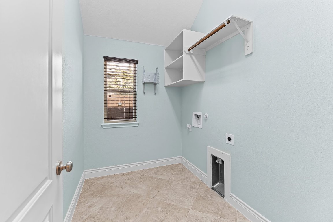 217 Serrano Street Georgetown, TX 78628 - Photo 8 of 27 a view of a kitchen with white cabinets and a window